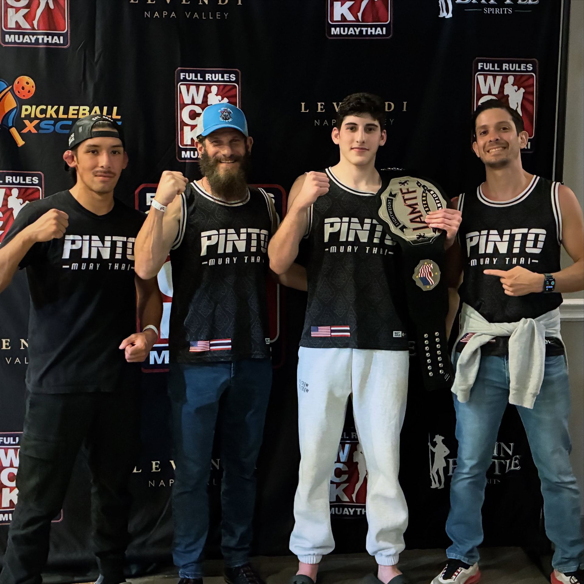 Asher Tessler with his belt and Muay Thai team