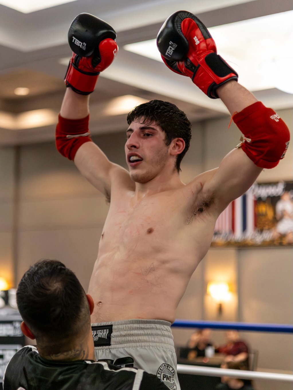 Asher Tessler raising his gloves in the ring