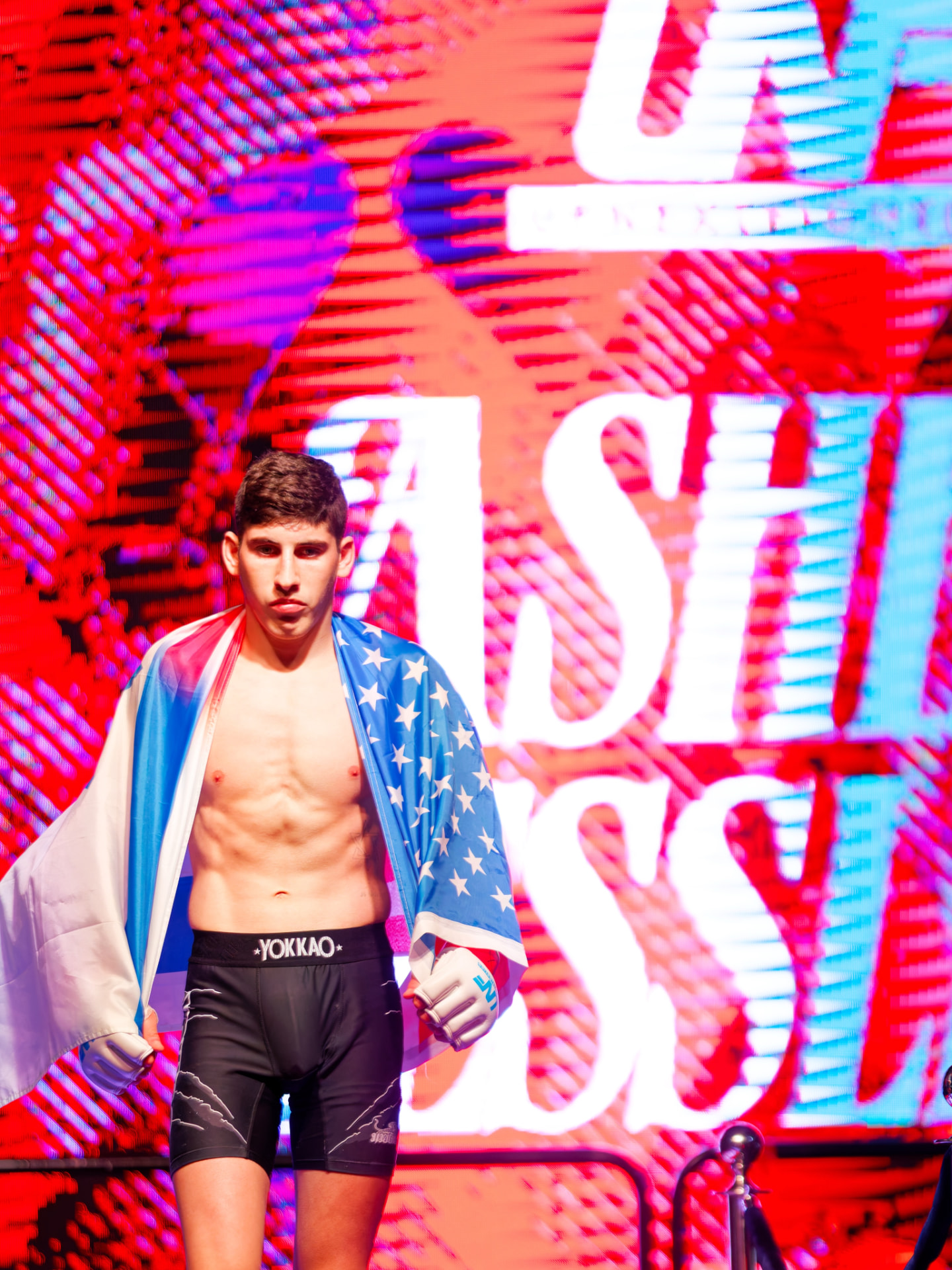 Asher Tessler entering the arena draped in a flag